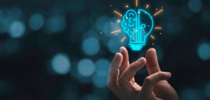 Hand holding drawing virtual lightbulb with brain on bokeh background for creative and smart thinking idea concep